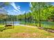 Picturesque lakefront with a swing, sandy beach, and clear water for recreation at 2334 Fisher Dr, Loganville, GA 30052