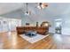Open-concept living room with hardwood floors, lots of seating and easy access to kitchen and front foyer at 2334 Fisher Dr, Loganville, GA 30052