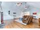 Bright living room with vaulted ceilings, hardwood floors, and an open layout great for entertaining Gathering and friends at 2334 Fisher Dr, Loganville, GA 30052