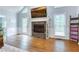 Beautiful living room featuring a stone fireplace with hardwood floors and natural light at 2334 Fisher Dr, Loganville, GA 30052