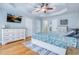 Spacious main bedroom featuring a tray ceiling, hardwood floors, and neutral paint at 2334 Fisher Dr, Loganville, GA 30052