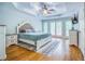 Main bedroom with tray ceiling, wood floors, double doors to a porch, and neutral decor at 2334 Fisher Dr, Loganville, GA 30052
