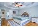 This bedroom features a tray ceiling, ceiling fan, and light blue walls at 2334 Fisher Dr, Loganville, GA 30052