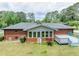 Expansive backyard boasts a well-kept lawn, a brick exterior, and a gray back deck perfect for entertaining at 3089 Ranlo Dr, Atlanta, GA 30340