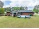 Spacious backyard features a well-maintained lawn, a gray deck, and a brick exterior with many windows at 3089 Ranlo Dr, Atlanta, GA 30340
