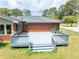 Brick exterior features a large gray deck in a spacious backyard with a well-manicured lawn at 3089 Ranlo Dr, Atlanta, GA 30340