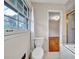 Bright bathroom showing toilet, window and glimpse into an adjoining bedroom at 3089 Ranlo Dr, Atlanta, GA 30340