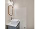 Powder room featuring a contemporary vanity, designer mirror, and modern lighting fixtures at 3089 Ranlo Dr, Atlanta, GA 30340