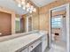 Bathroom featuring an extended countertop, large mirror, and a view into the shower area at 3089 Ranlo Dr, Atlanta, GA 30340