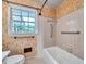 Bathroom showcasing a tub and shower combination with neutral tile and a window at 3089 Ranlo Dr, Atlanta, GA 30340