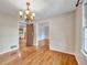 Dining room featuring wood floors, chandelier, and windows with outdoor views at 3089 Ranlo Dr, Atlanta, GA 30340