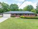 Charming single-story brick home featuring a well-manicured front lawn and attached garage at 3089 Ranlo Dr, Atlanta, GA 30340