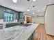 Open-concept kitchen featuring marble island, stainless appliances, and an adjacent living space at 3089 Ranlo Dr, Atlanta, GA 30340