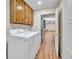 Laundry room with washer, dryer, wooden cabinets and laminate flooring at 3089 Ranlo Dr, Atlanta, GA 30340