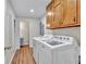 Functional laundry room featuring modern appliances, ample storage, and durable laminate flooring at 3089 Ranlo Dr, Atlanta, GA 30340