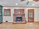 Living room with a brick fireplace, wood floors, and natural light, perfect for relaxation at 3089 Ranlo Dr, Atlanta, GA 30340