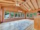 Bright sunroom boasts wood-paneled walls, ceilings, and trim, along with brick accents and an abundance of windows at 3089 Ranlo Dr, Atlanta, GA 30340