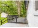 Spacious deck on home with a wooded back yard and white brick exterior at 493 Woods Nw Dr, Atlanta, GA 30318