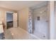 Bathroom featuring dual sinks, updated vanity, tiled shower, and wood-look floors at 493 Woods Nw Dr, Atlanta, GA 30318