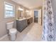 Bathroom with dual sinks, updated vanity, large mirror, and shower with curtain at 493 Woods Nw Dr, Atlanta, GA 30318