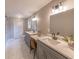 Bathroom featuring dual sinks, vanity, large mirror, and updated lighting fixtures at 493 Woods Nw Dr, Atlanta, GA 30318