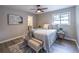 Bedroom with ceiling fan, bed with decorative pillows, bench, and wood-look floors at 493 Woods Nw Dr, Atlanta, GA 30318