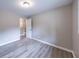 Bedroom with light gray color scheme, wood-look floors, view to another room, and closet at 493 Woods Nw Dr, Atlanta, GA 30318