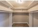 Walk-in closet with custom shelving and hanging rods perfect for organization and storage at 493 Woods Nw Dr, Atlanta, GA 30318