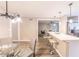 Open concept dining area next to the kitchen with modern lighting and easy access to the living area at 493 Woods Nw Dr, Atlanta, GA 30318