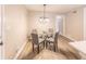Dining area features a glass table with four chairs and a view of the adjacent kitchen and other rooms at 493 Woods Nw Dr, Atlanta, GA 30318