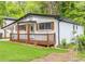 Inviting home with covered front porch, white painted brick and black trimmed windows at 493 Woods Nw Dr, Atlanta, GA 30318
