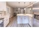Bright kitchen with white cabinets and countertops, stainless steel refrigerator, and dining area at 493 Woods Nw Dr, Atlanta, GA 30318