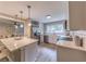 Well-lit kitchen featuring white cabinets, stainless steel appliances, subway tile backsplash, and an adjacent living area at 493 Woods Nw Dr, Atlanta, GA 30318