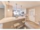 Bright kitchen features an island with bar seating, white cabinets and countertops and stainless steel appliances at 493 Woods Nw Dr, Atlanta, GA 30318