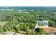 Aerial view of a home in a wooded area, with an inset image highlighting the property's facade at 5652 Burruss Rd, Cumming, GA 30028
