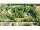 Breathtaking aerial view showcasing a home surrounded by lush greenery, and a tree-lined property at 5652 Burruss Rd, Cumming, GA 30028