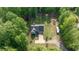 Aerial view of a home with lush greenery, a long driveway, and ample space between neighboring houses at 5652 Burruss Rd, Cumming, GA 30028