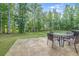 Inviting backyard patio with table, seating, and a lush green lawn, perfect for outdoor enjoyment at 5652 Burruss Rd, Cumming, GA 30028