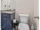 Well-lit half bath features a granite countertop vanity and modern fixtures at 5652 Burruss Rd, Cumming, GA 30028