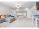 Expansive bonus room with gray sectional, carpet, and TV at 5652 Burruss Rd, Cumming, GA 30028