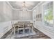 Elegant dining room featuring modern lighting, wainscoting, and a large window at 5652 Burruss Rd, Cumming, GA 30028