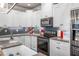 Updated kitchen showcasing granite countertops, stainless appliances, and modern backsplash at 5652 Burruss Rd, Cumming, GA 30028