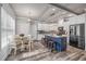 Bright kitchen features an island with seating, stainless steel appliances, and adjacent breakfast nook area at 5652 Burruss Rd, Cumming, GA 30028