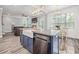 Spacious kitchen with a large kitchen island and direct view to the connected living room at 5652 Burruss Rd, Cumming, GA 30028