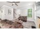 Inviting living room featuring wood flooring, modern ceiling fan and staircase access to the second floor at 5652 Burruss Rd, Cumming, GA 30028