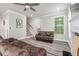 Inviting living room featuring wood flooring, modern ceiling fan and staircase access to the second floor at 5652 Burruss Rd, Cumming, GA 30028