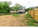 Spacious backyard view of the two-story home, showing outdoor staircase, lawn and fencing at 788 Fayetteville Se Rd, Atlanta, GA 30316