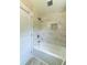 Bathroom boasts tiled shower with bench and marble style wall tiles at 788 Fayetteville Se Rd, Atlanta, GA 30316