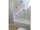 Bright bathroom featuring marble-style tile surround in the tub and shower at 788 Fayetteville Se Rd, Atlanta, GA 30316