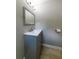 Bathroom features a gray single sink vanity with a mirror and neutral walls at 788 Fayetteville Se Rd, Atlanta, GA 30316